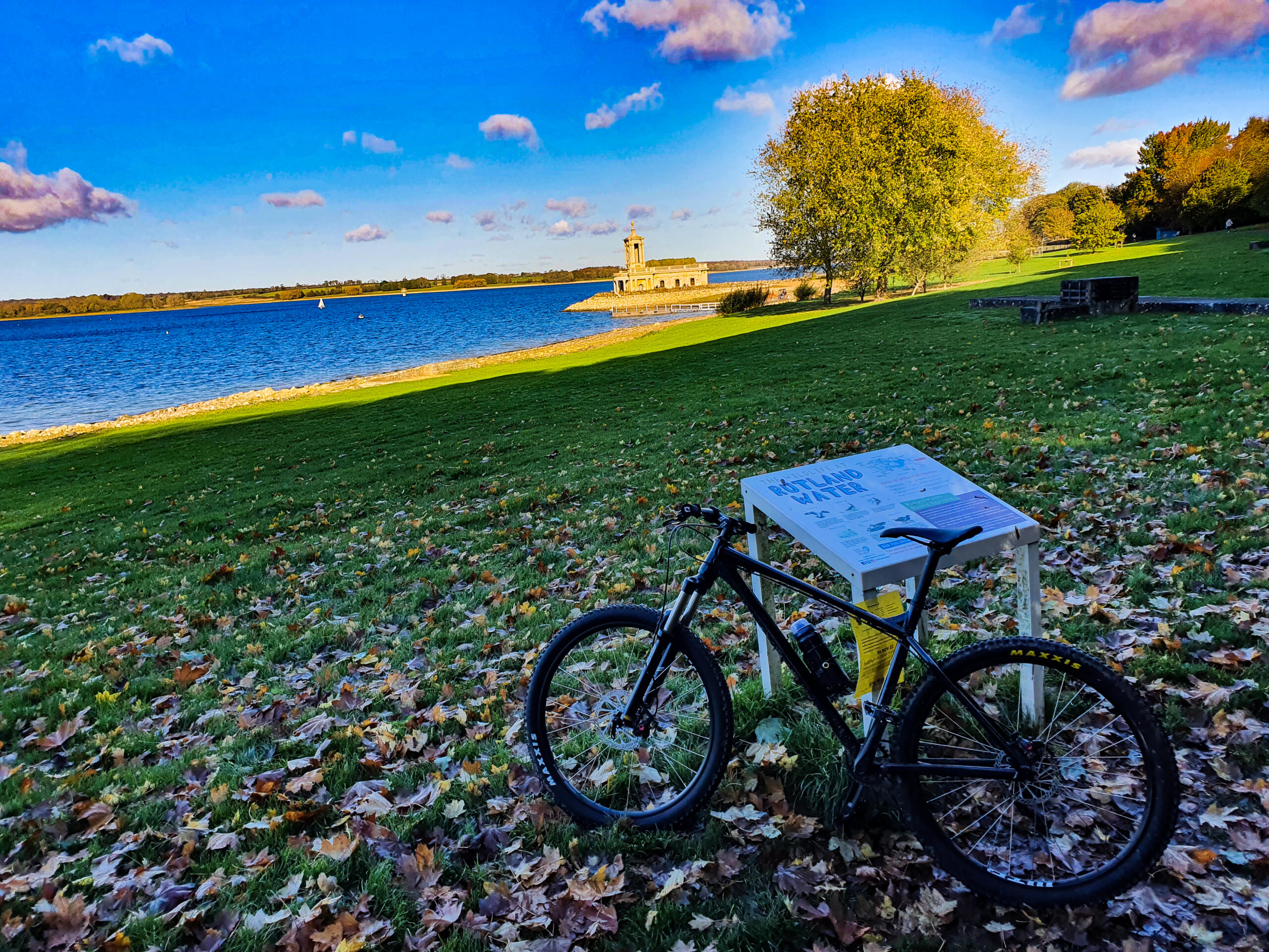 Bike infront of Rutland Water reservoir with Normanton Church in the background
